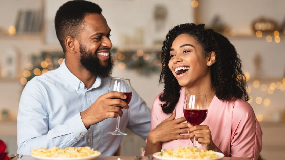 How to spend more quality time with your family couple laughing with wine glasses